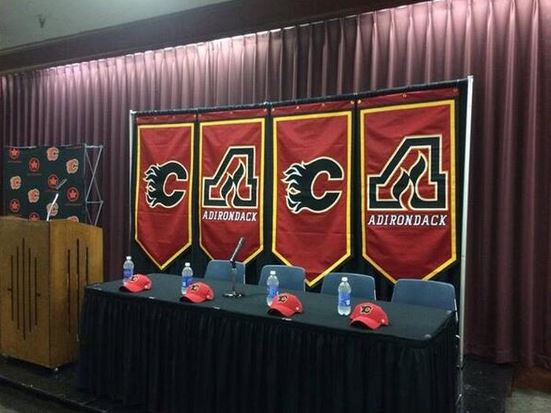 Banners at Flames minor league hockey announcement spell “Caca”