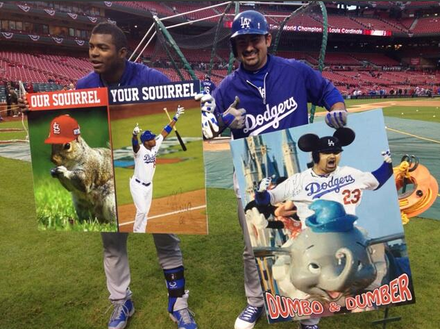 Yasiel Puig and Adrian Gonzalez pose with dumbo and squirrel signs